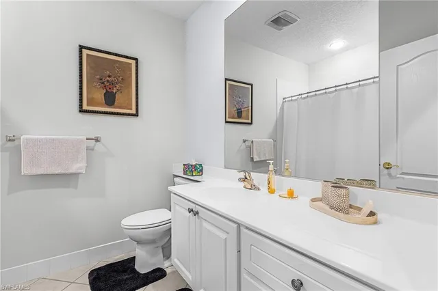a bathroom with a sink toilet and a mirror