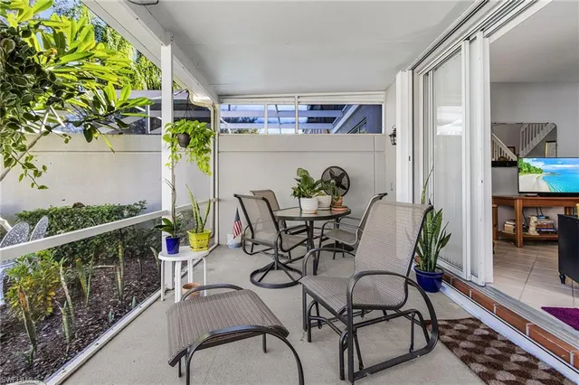 a view of a chairs and table in patio