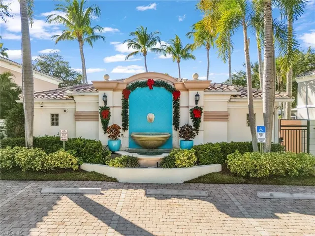 a front view of a multi story residential apartment building with a yard