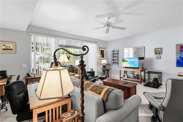 a living room with furniture a chandelier and a window