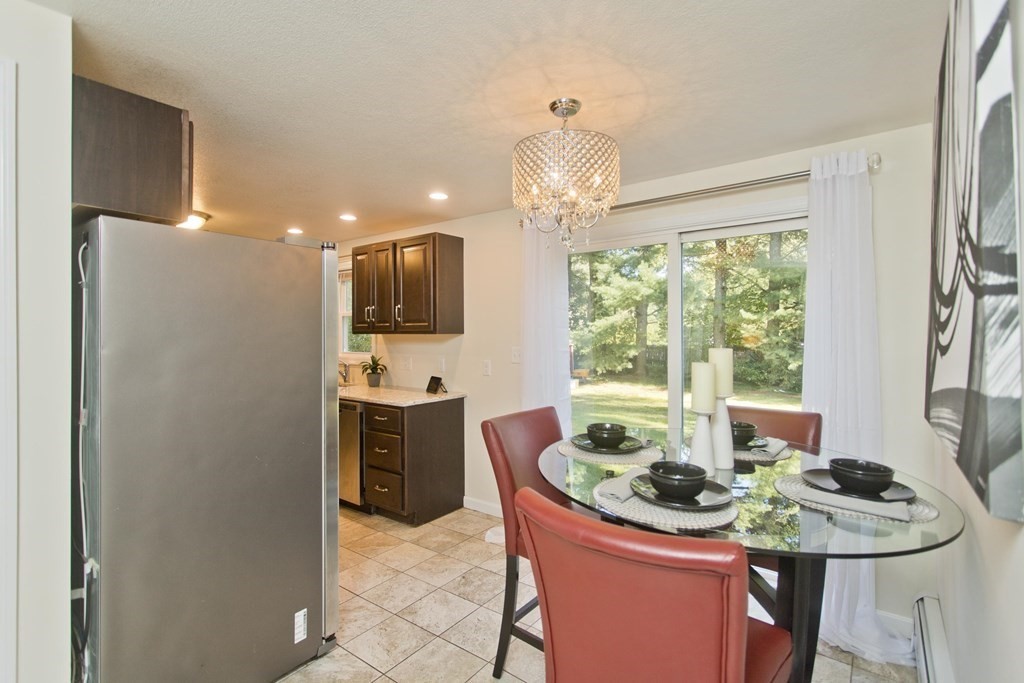 418 Ryan Road Northampton, MA 01062 - Photo 24 of 36 a dining room with furniture a large window and kitchen view