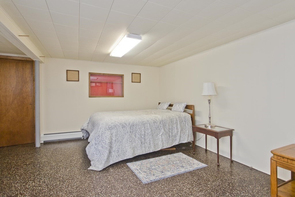 418 Ryan Road Northampton, MA 01062 - Photo 34 of 36 a bedroom with a bed and a lamp