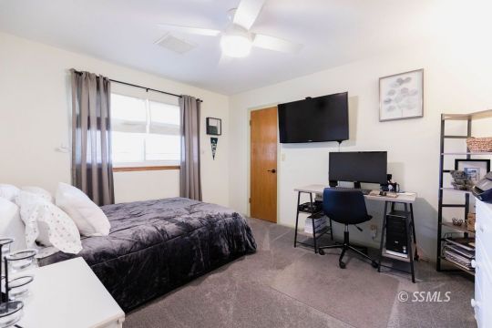908 North Inyo Street Ridgecrest, CA 93555 - Photo 31 of 46 a bedroom with a bed and a flat screen tv