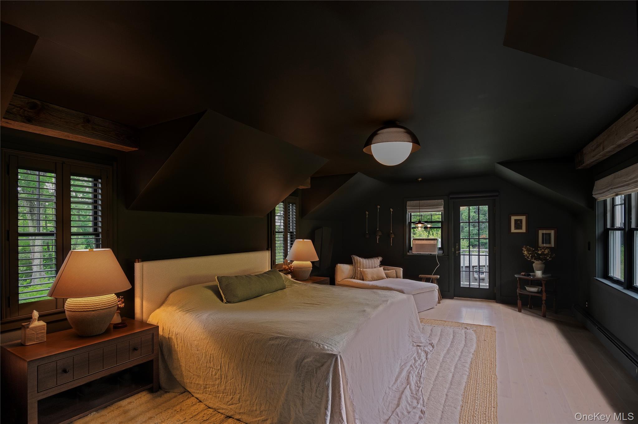 340 Upper Pine Kill Road Wurtsboro, NY 12790 - Photo 11 of 13 Large main bedroom with balcony and views of three sides of the house, the mountain the primary entrance and a quiet calming decor.