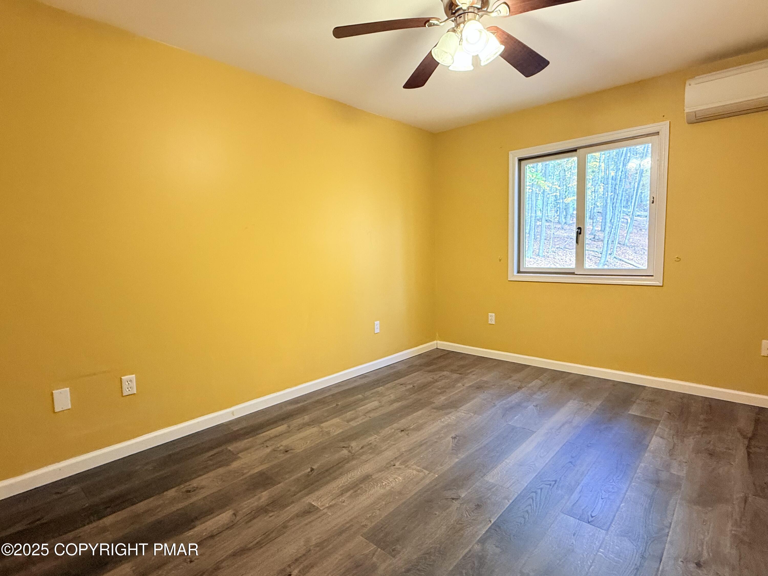 303 Otter Court Bushkill, PA 18324 - Photo 12 of 18 a view of an empty room with wooden floor and a window