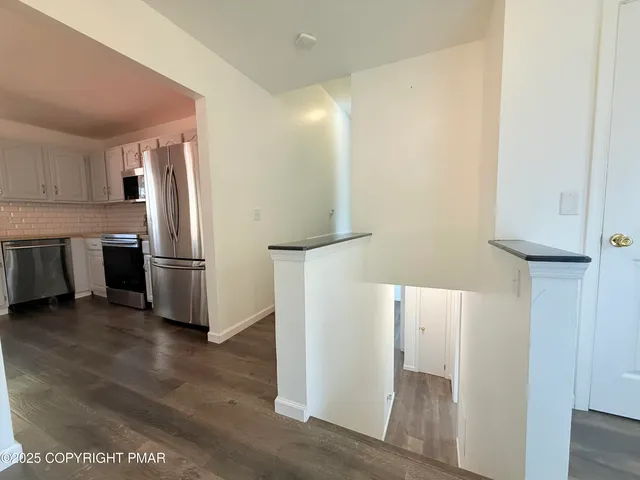 a kitchen with stainless steel appliances a refrigerator and a stove
