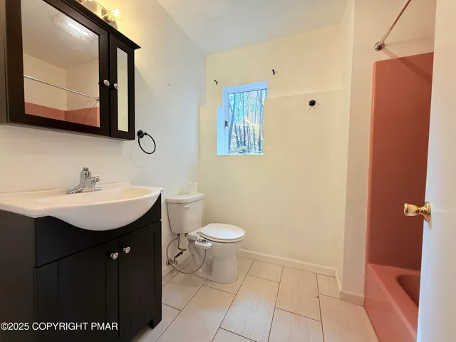 a bathroom with a sink a toilet and mirror