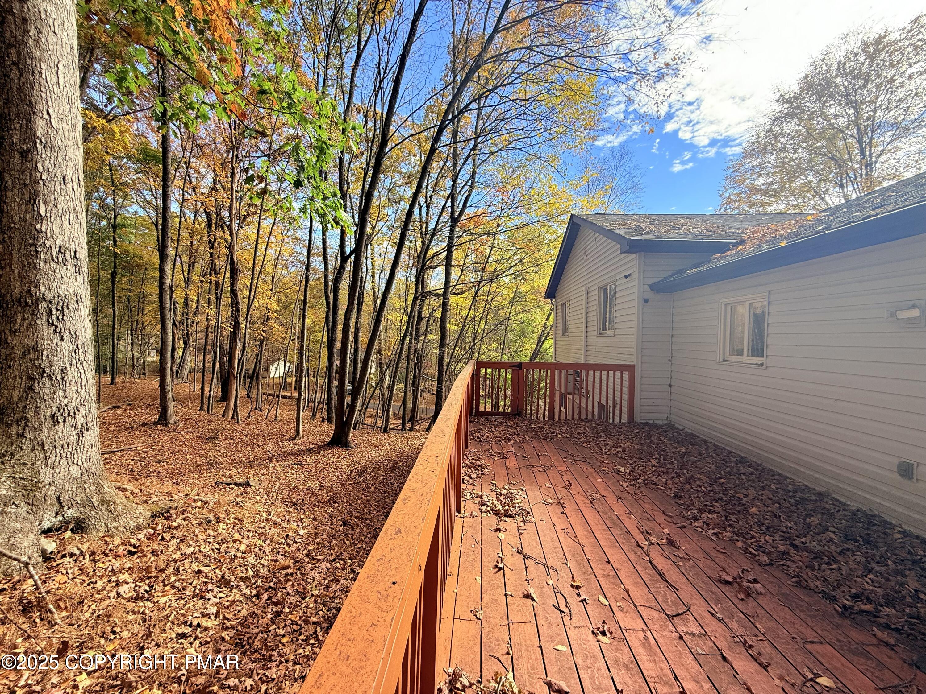 303 Otter Court Bushkill, PA 18324 - Photo 18 of 18 a view of a backyard with a deck