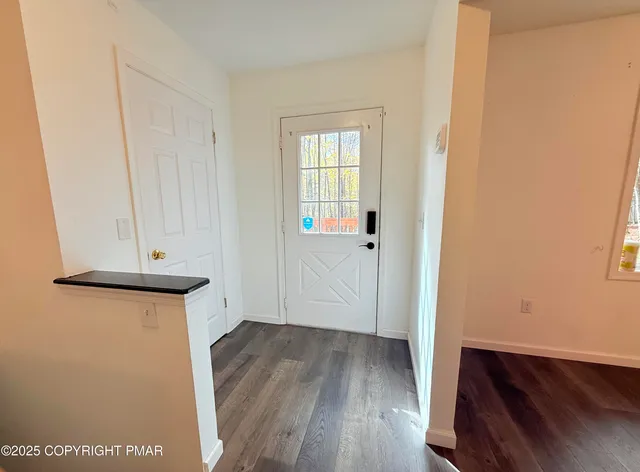 a view of a hallway with wooden floor