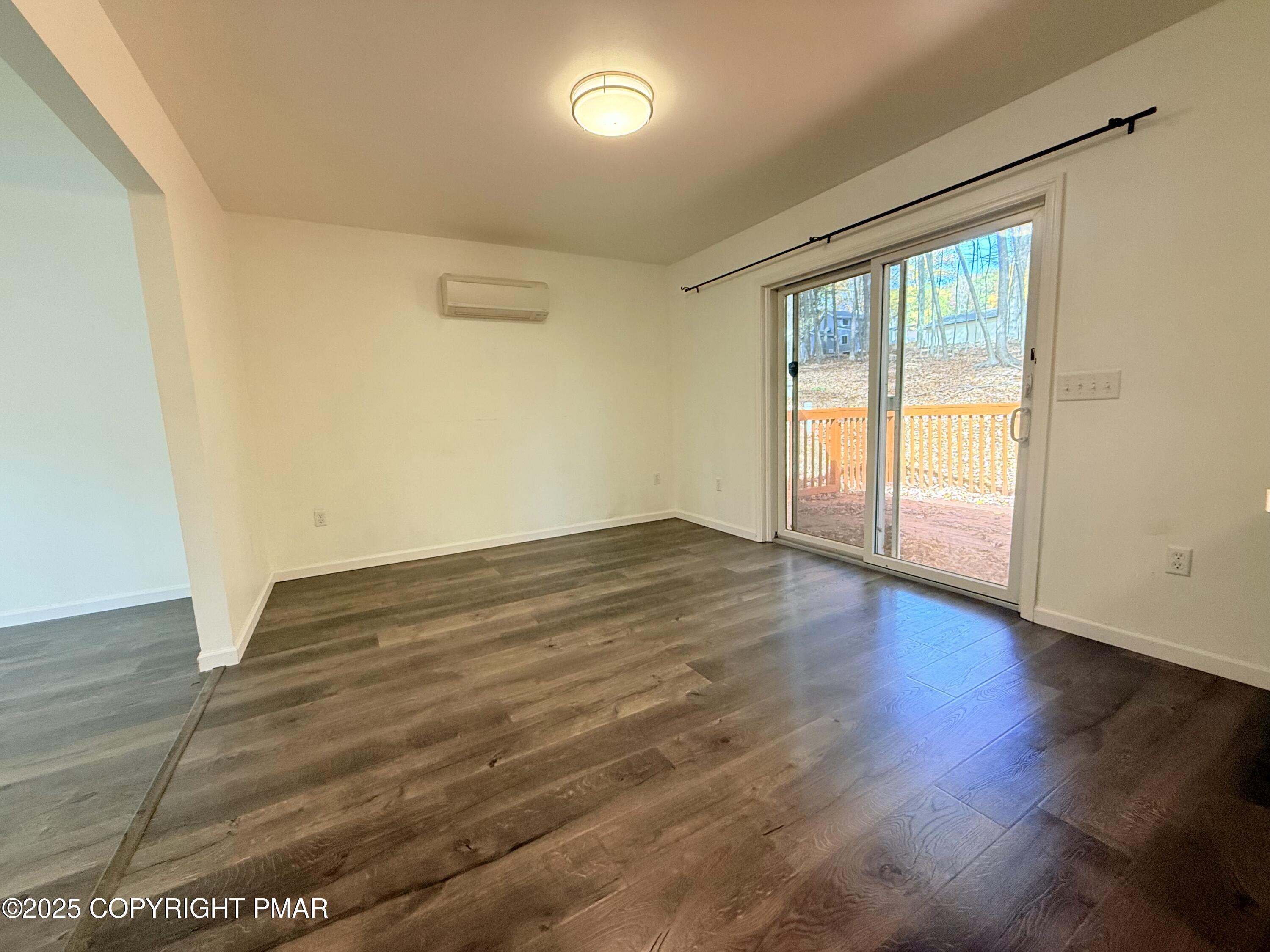303 Otter Court Bushkill, PA 18324 - Photo 5 of 18 an empty room with wooden floor and windows