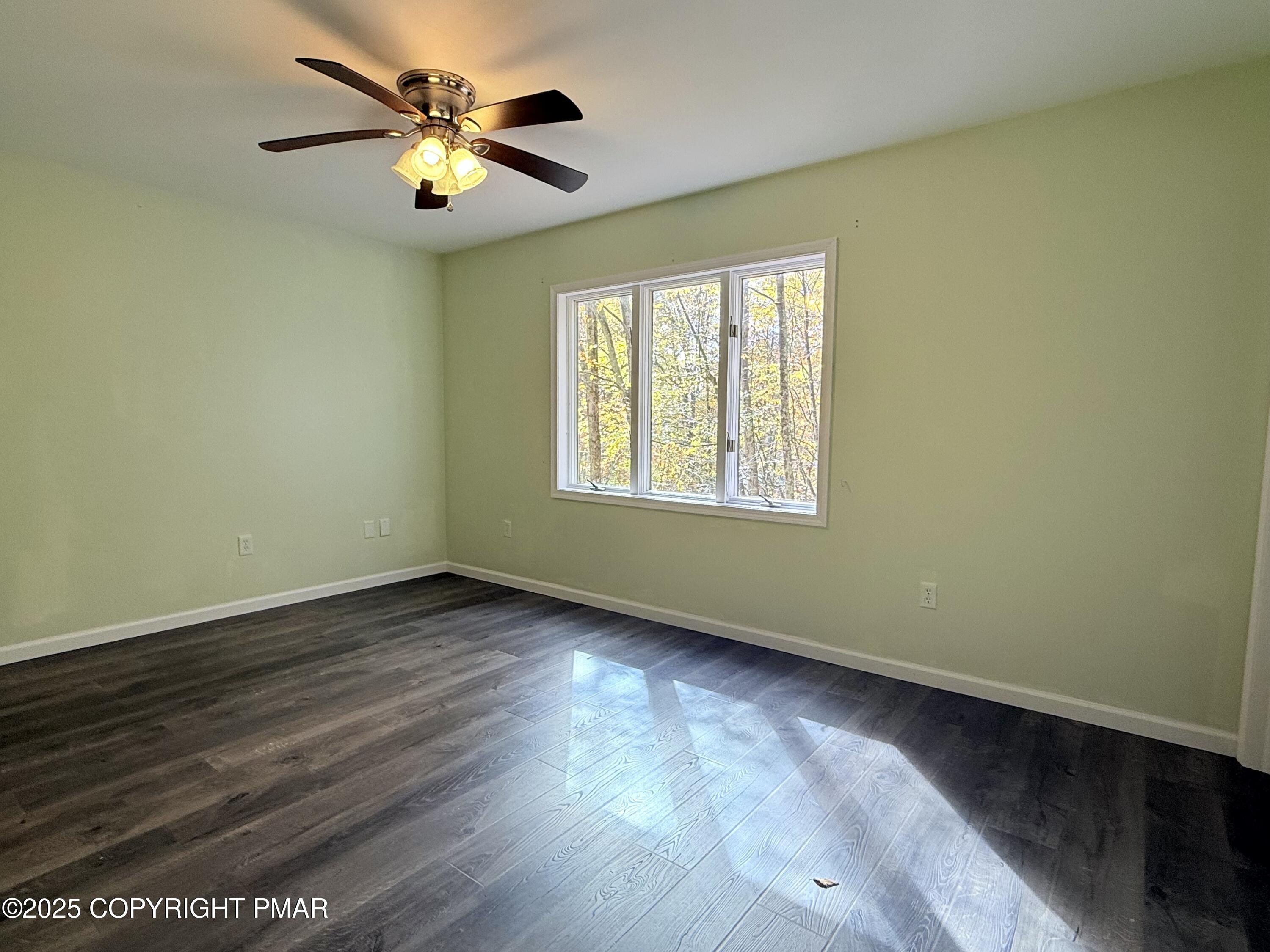 303 Otter Court Bushkill, PA 18324 - Photo 9 of 18 a view of an empty room with wooden floor and a window