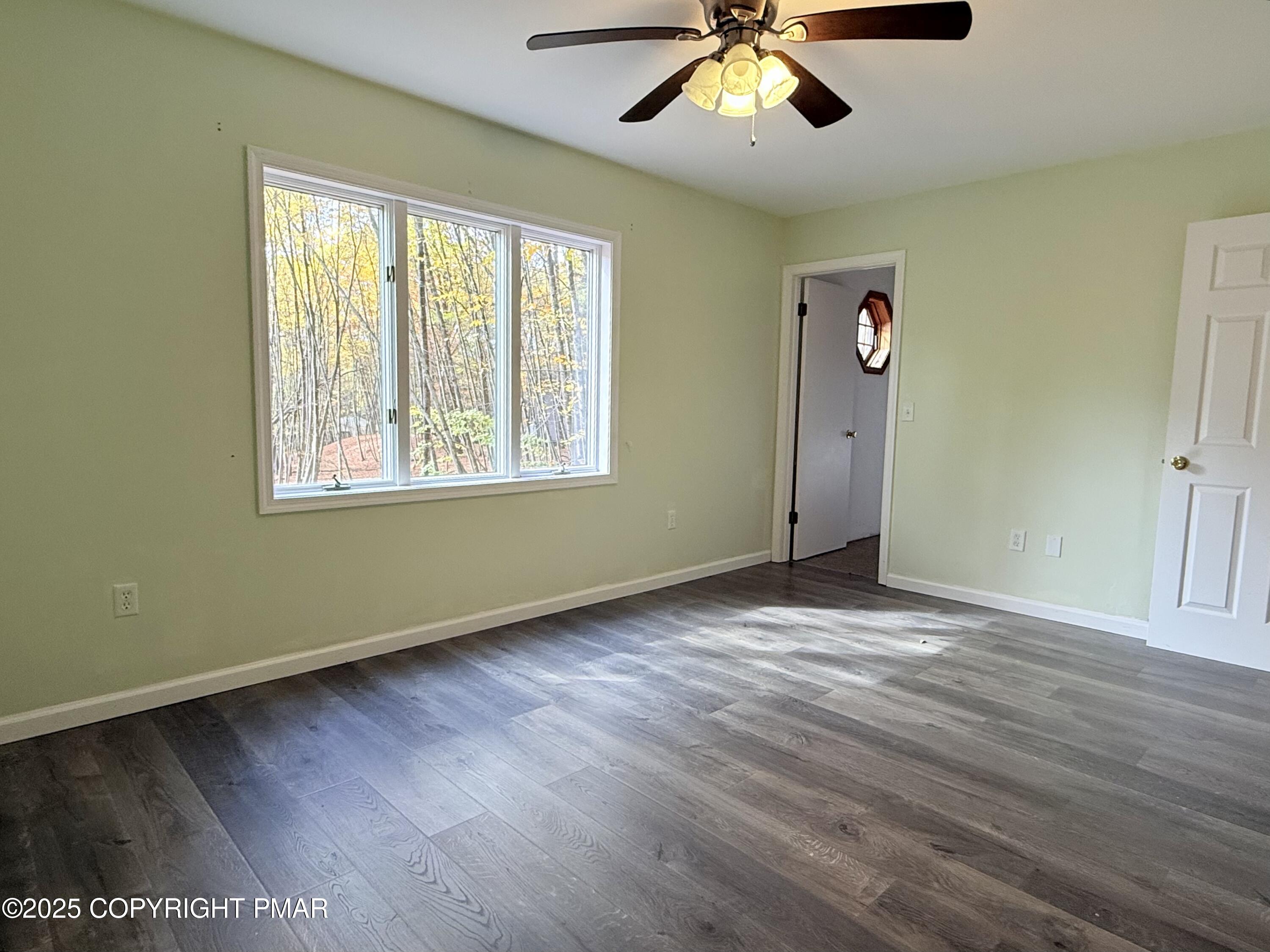 303 Otter Court Bushkill, PA 18324 - Photo 10 of 18 a view of an empty room with wooden floor and a window