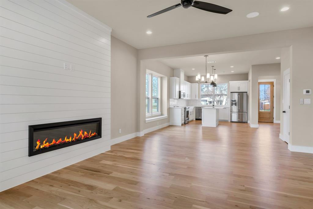 207 West 7th Street Justin, TX 76247 - Photo 12 of 40 a view of a living room a fireplace and wooden floor