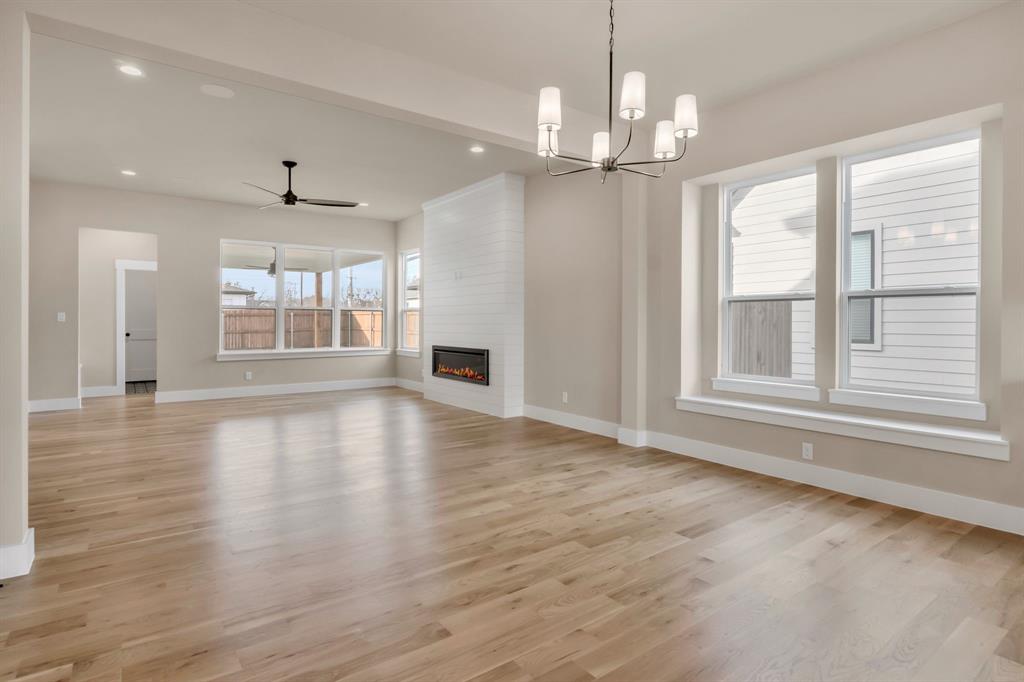 207 West 7th Street Justin, TX 76247 - Photo 15 of 40 a view of an empty room with wooden floor and a window