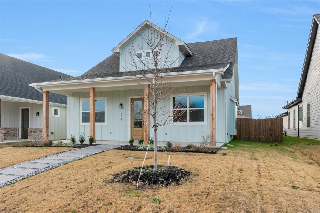 207 West 7th Street Justin, TX 76247 - Photo 2 of 40 a front view of a house with a yard