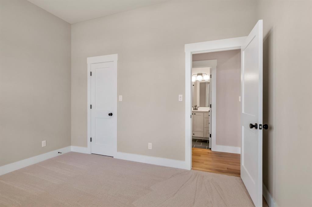 207 West 7th Street Justin, TX 76247 - Photo 25 of 40 a view of a hallway with wooden floor and a bathroom