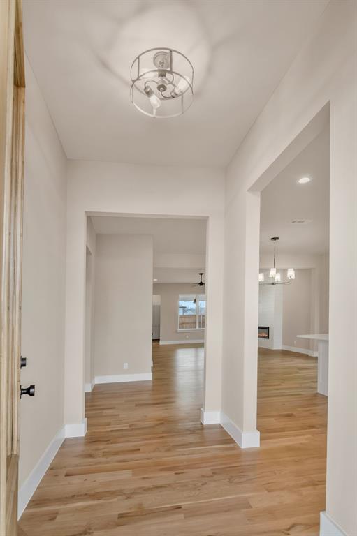 207 West 7th Street Justin, TX 76247 - Photo 5 of 40 a view of a hallway with wooden floor