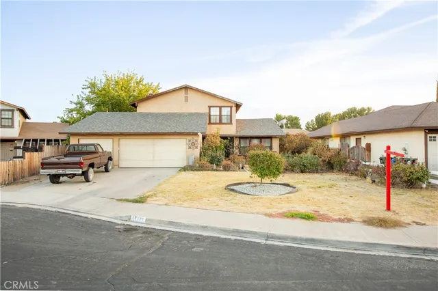 a view of a house with car parked