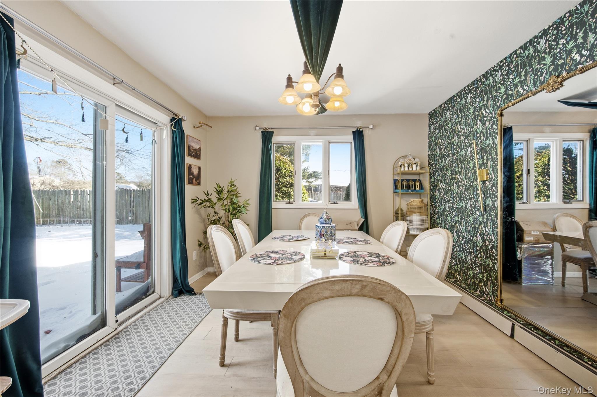 50 Rustic Avenue Medford, NY 11763 - Photo 6 of 20 a dining room with furniture a rug a potted plant and a chandelier