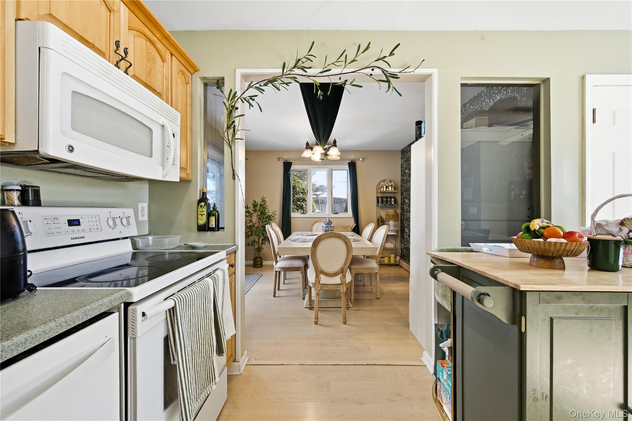 50 Rustic Avenue Medford, NY 11763 - Photo 8 of 20 a kitchen with a sink refrigerator and cabinets