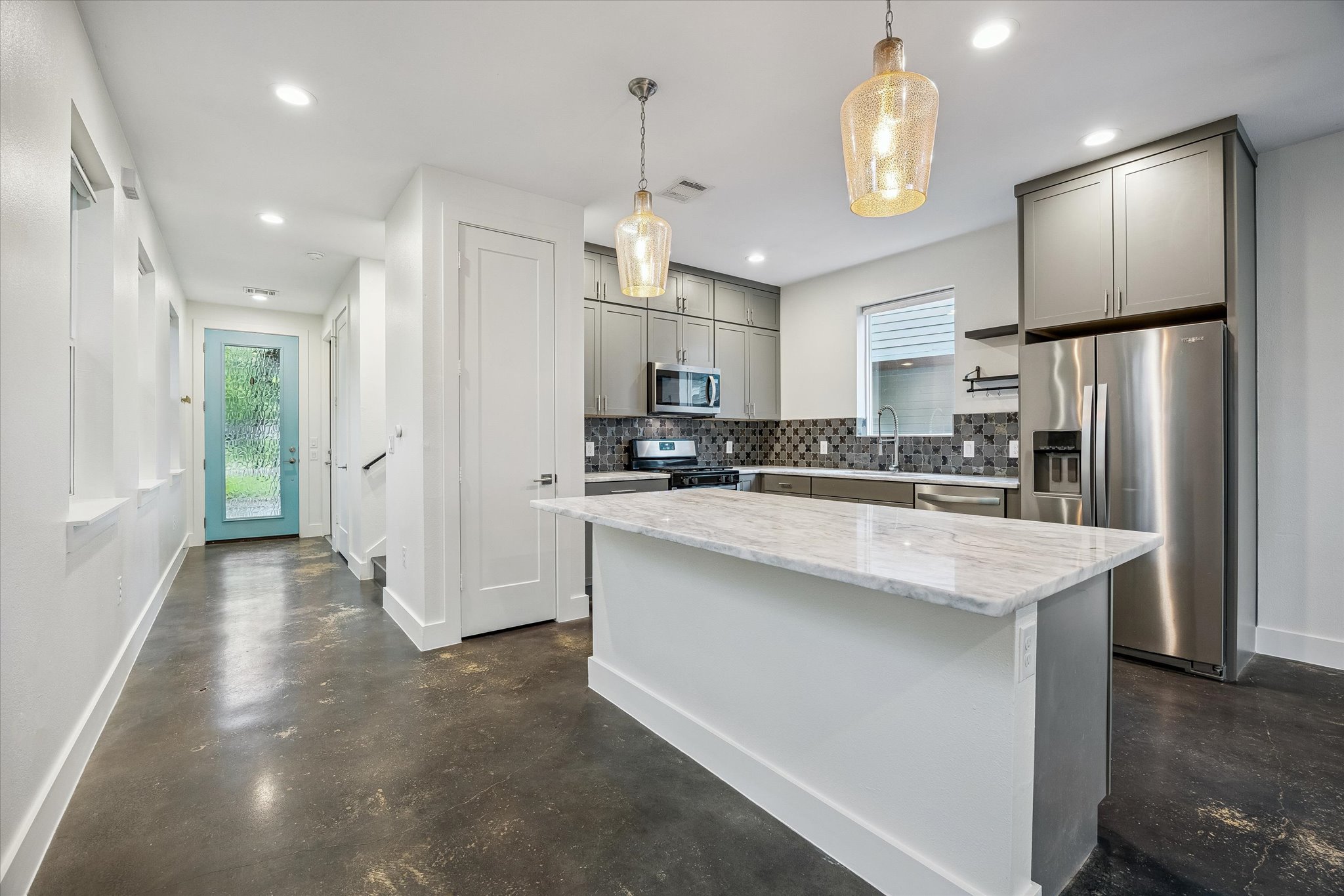 1224 Eleanor Street, Unit 1 Austin, TX 78721 - Photo 3 of 18 a kitchen with stainless steel appliances granite countertop a refrigerator a sink dishwasher a refrigerator and white cabinets with wooden floor