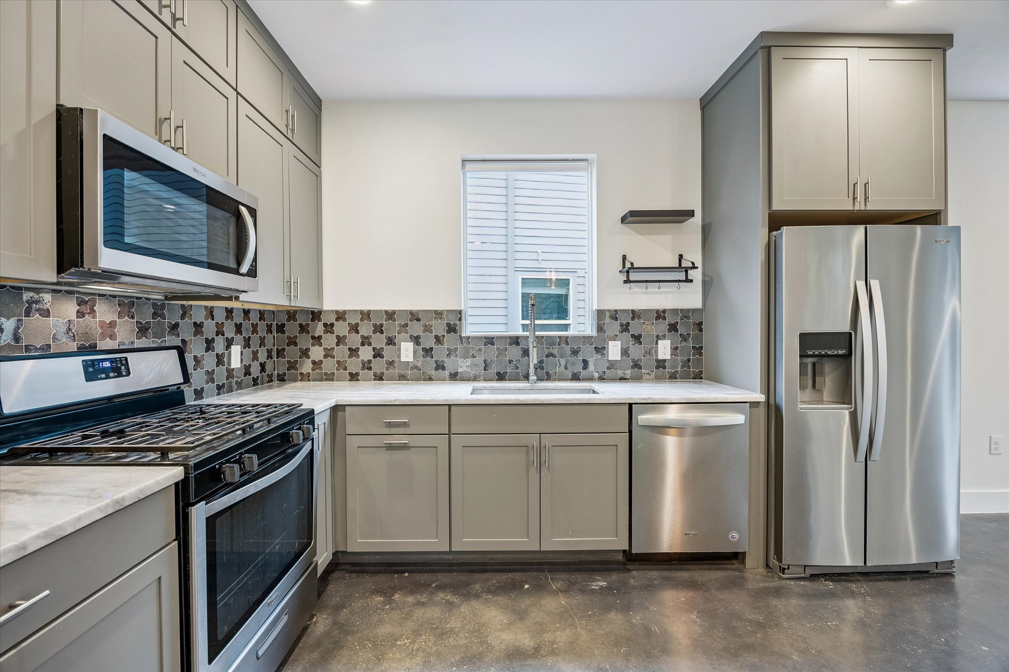 1224 Eleanor Street, Unit 1 Austin, TX 78721 - Photo 5 of 18 a kitchen with stainless steel appliances a stove sink and refrigerator