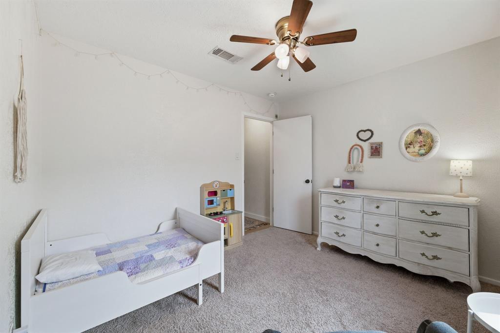 224 Overcrest Drive Benbrook, TX 76126 - Photo 27 of 39 a bedroom with a bed and a chandelier