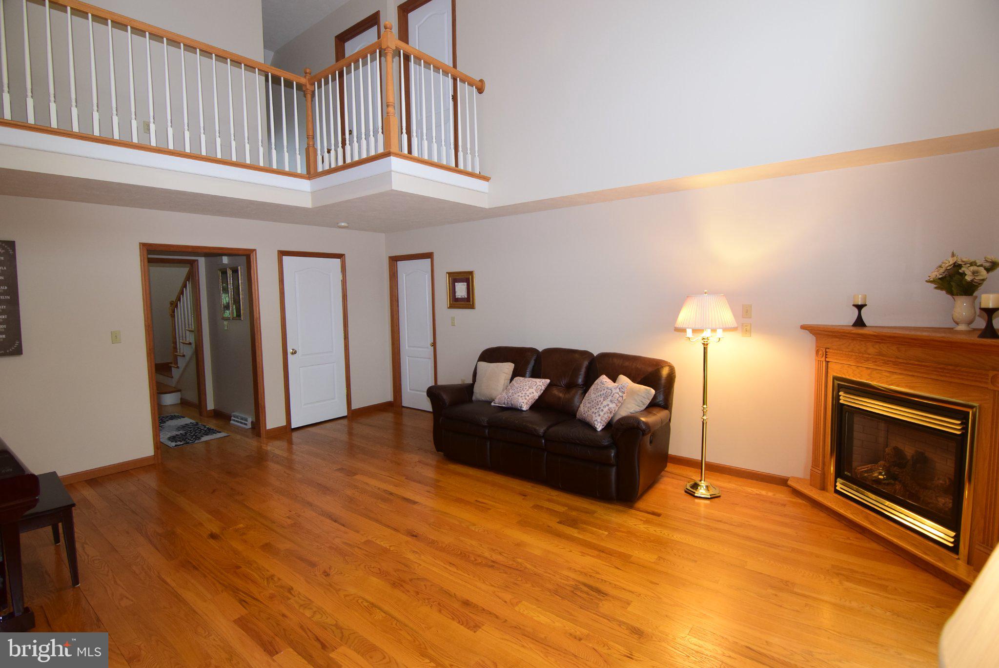 470 Millgate Road Bellefonte, PA 16823 - Photo 16 of 63 a living room with furniture a fireplace and a flat screen tv