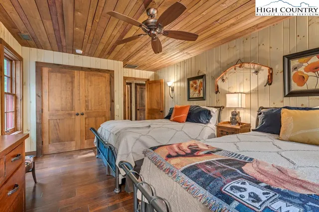 a bedroom with bed and a chandelier