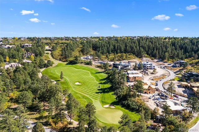 a view of a swimming pool with a patio and a yard