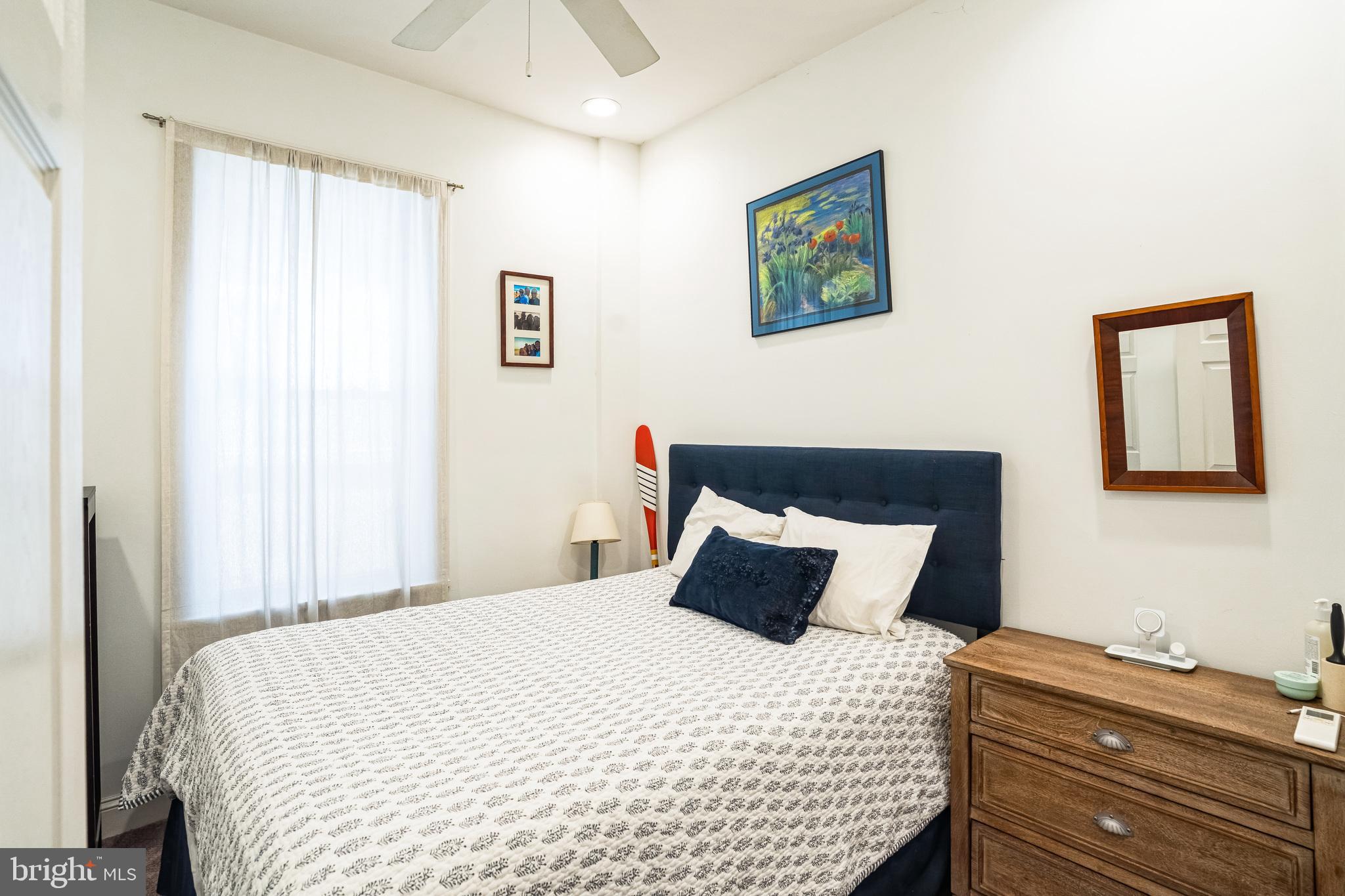 2124 Spruce Street, Unit 1R Philadelphia, PA 19103 - Photo 11 of 17 a bedroom with a bed and a window