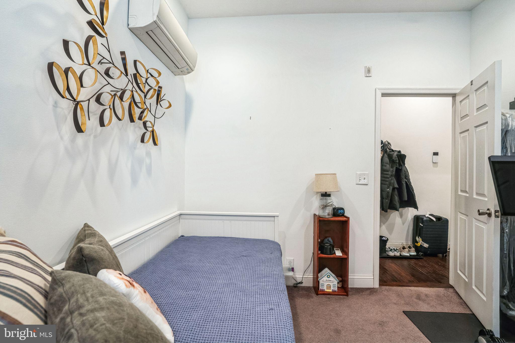 2124 Spruce Street, Unit 1R Philadelphia, PA 19103 - Photo 15 of 17 a bedroom with a bed and a chandelier