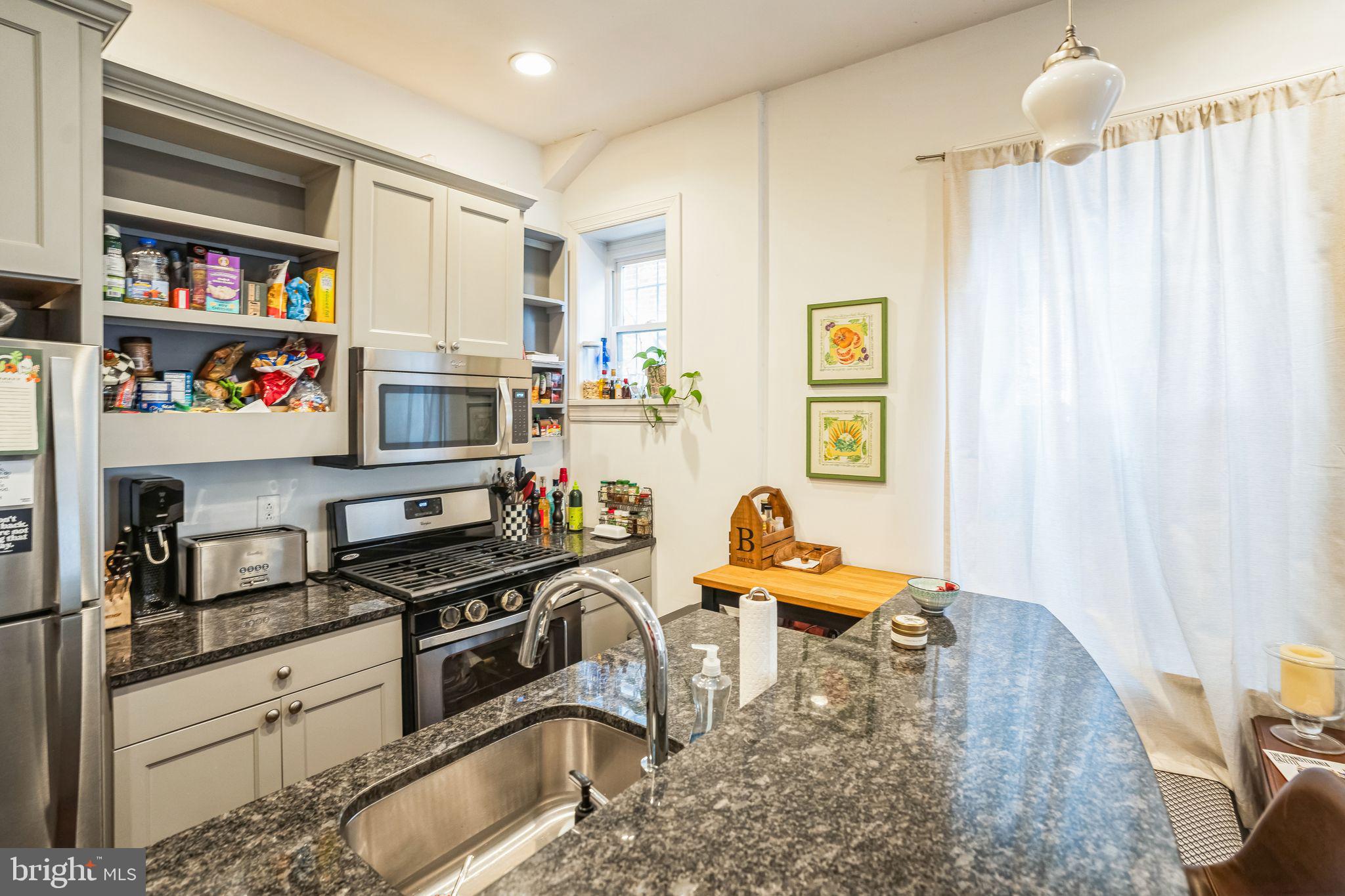 2124 Spruce Street, Unit 1R Philadelphia, PA 19103 - Photo 4 of 17 a kitchen with stainless steel appliances a sink a stove and a refrigerator