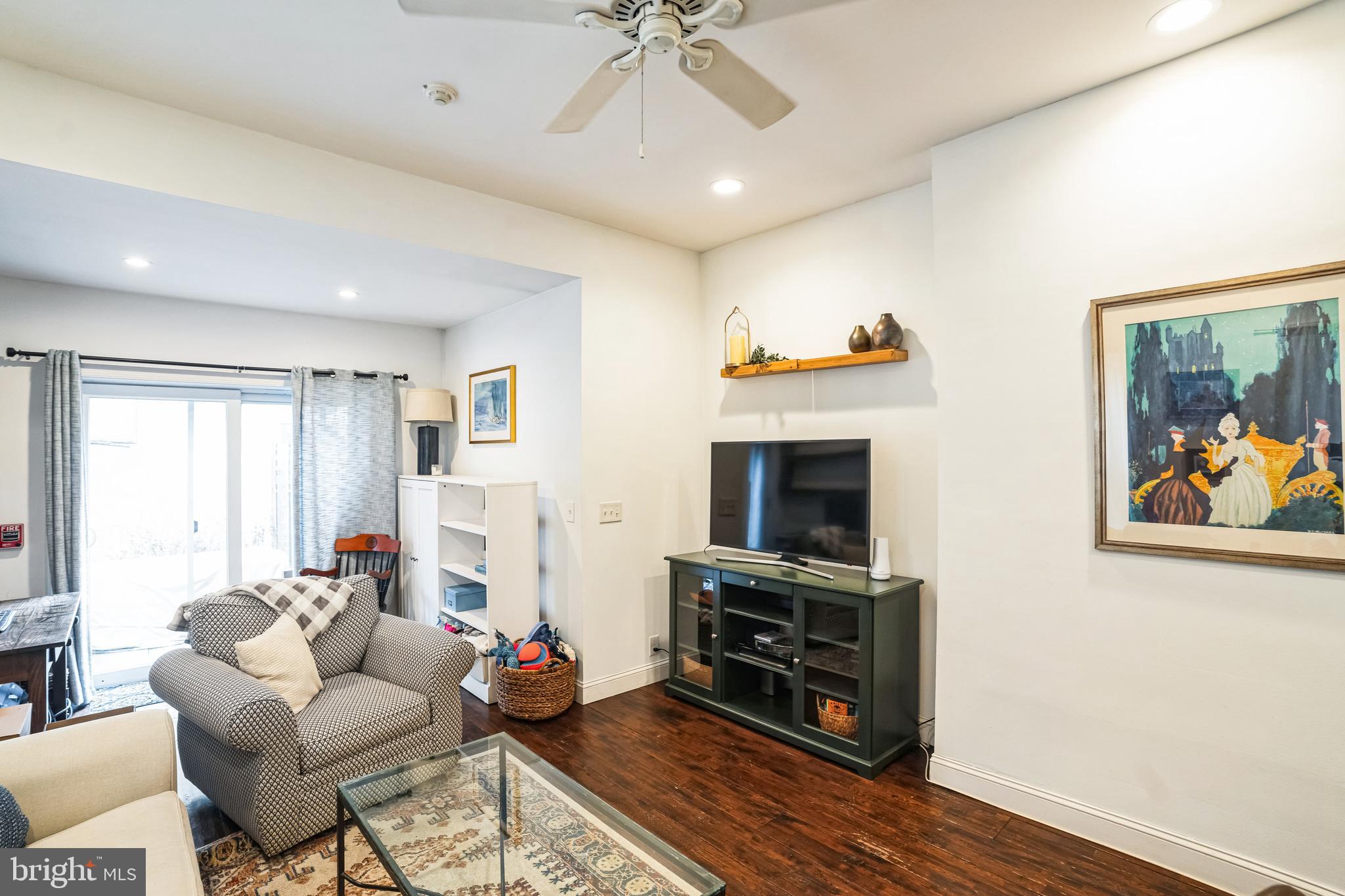 2124 Spruce Street, Unit 1R Philadelphia, PA 19103 - Photo 6 of 17 a living room with furniture a fireplace and a flat screen tv