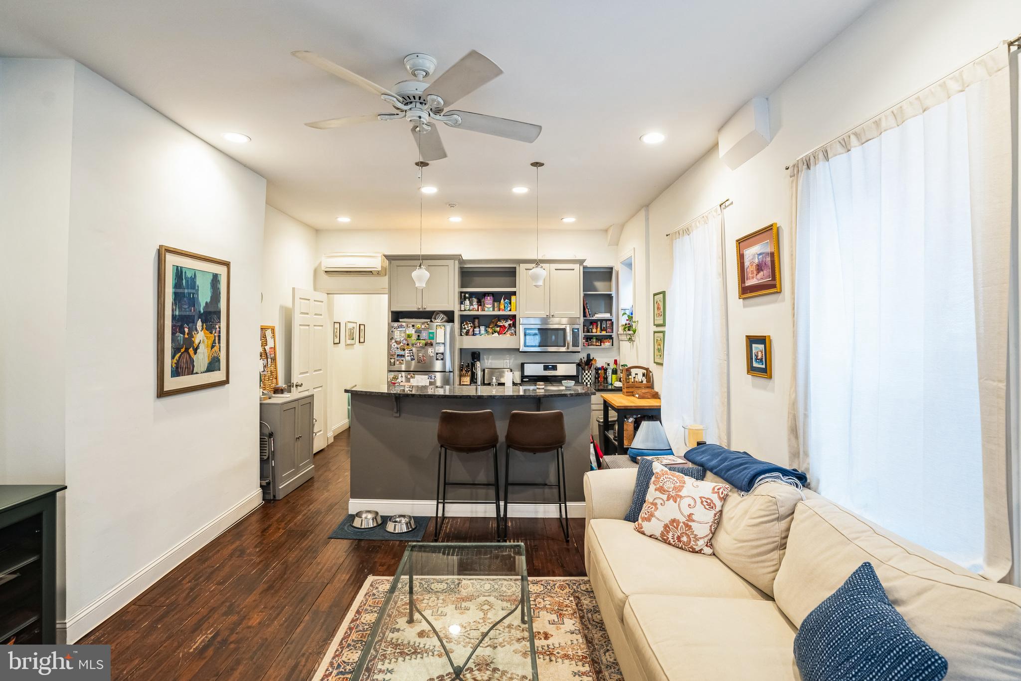 2124 Spruce Street, Unit 1R Philadelphia, PA 19103 - Photo 8 of 17 a living room with furniture and kitchen view