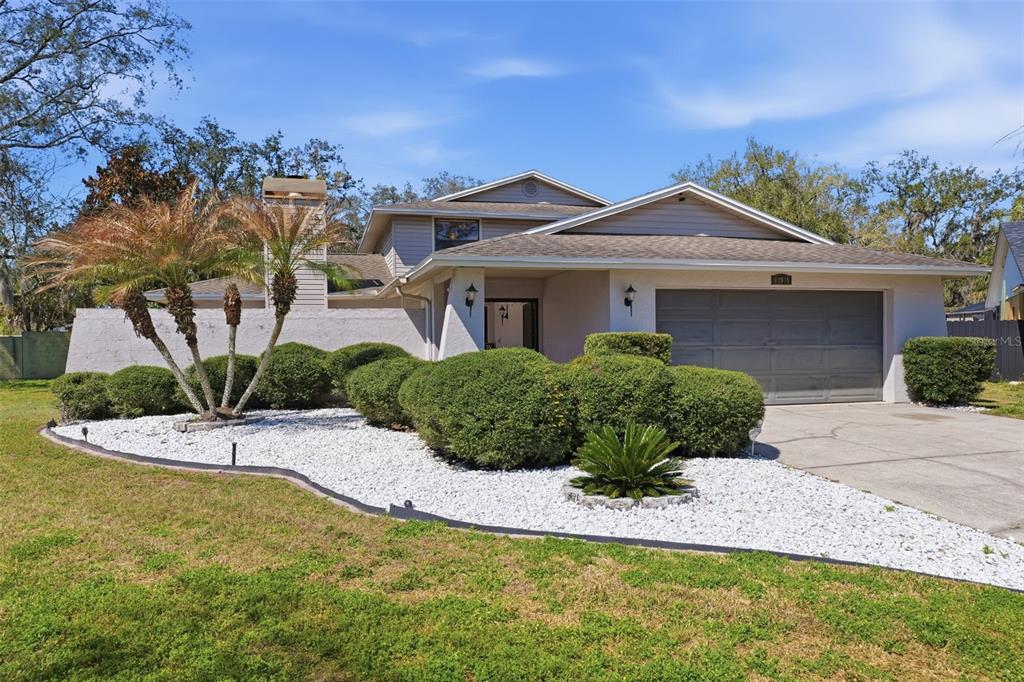 12935 Rain Forest Street Temple Terrace, FL 33617 - Photo 1 of 51 a front view of a house with a yard
