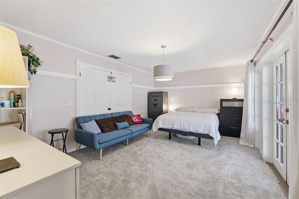 12935 Rain Forest Street Temple Terrace, FL 33617 - Photo 18 of 51 a spacious bedroom with a bed a couch and dresser