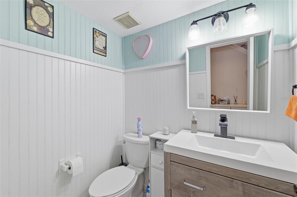 12935 Rain Forest Street Temple Terrace, FL 33617 - Photo 20 of 51 a bathroom with a toilet sink vanity and mirror