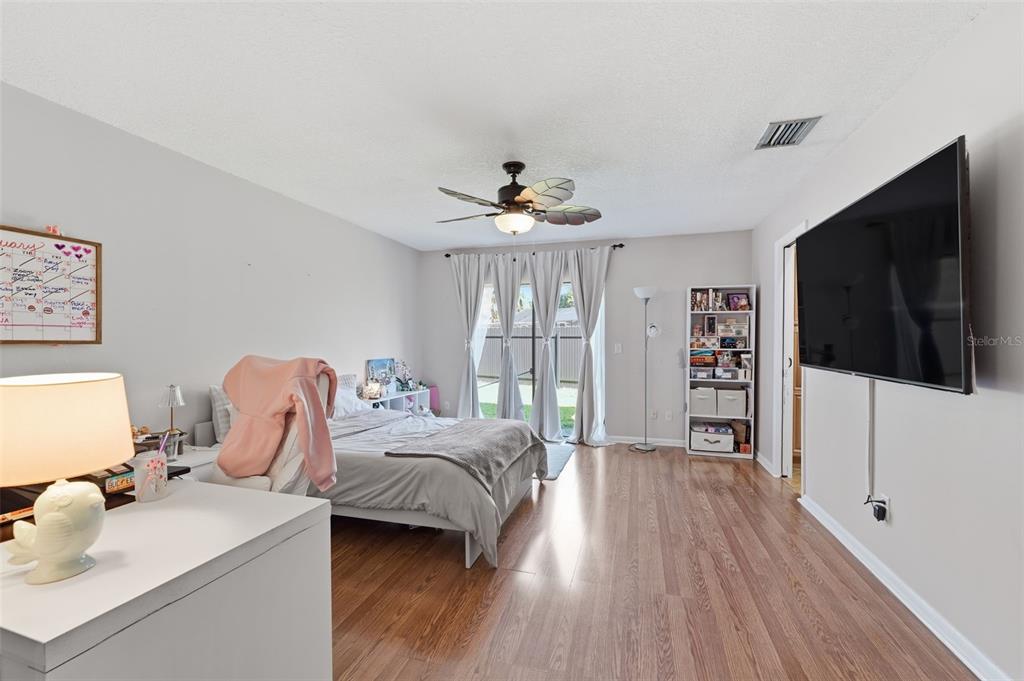 12935 Rain Forest Street Temple Terrace, FL 33617 - Photo 21 of 51 a bedroom with a bed and a flat screen tv