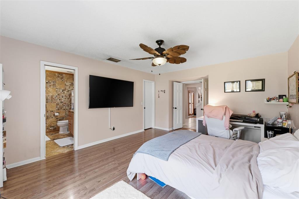 12935 Rain Forest Street Temple Terrace, FL 33617 - Photo 22 of 51 a bedroom with a bed and a flat screen tv
