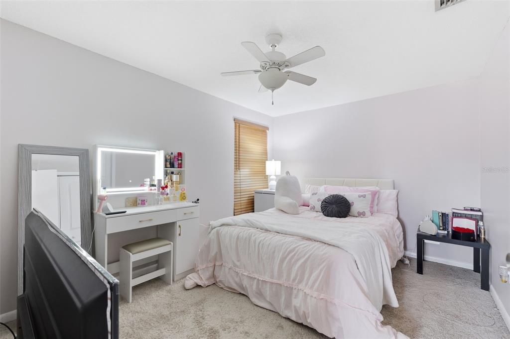 12935 Rain Forest Street Temple Terrace, FL 33617 - Photo 24 of 51 a bedroom with a bed and a chandelier