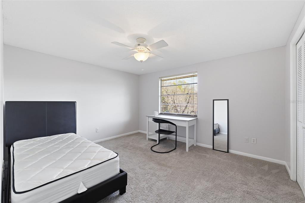 12935 Rain Forest Street Temple Terrace, FL 33617 - Photo 28 of 51 a bedroom with a bed and a table in it