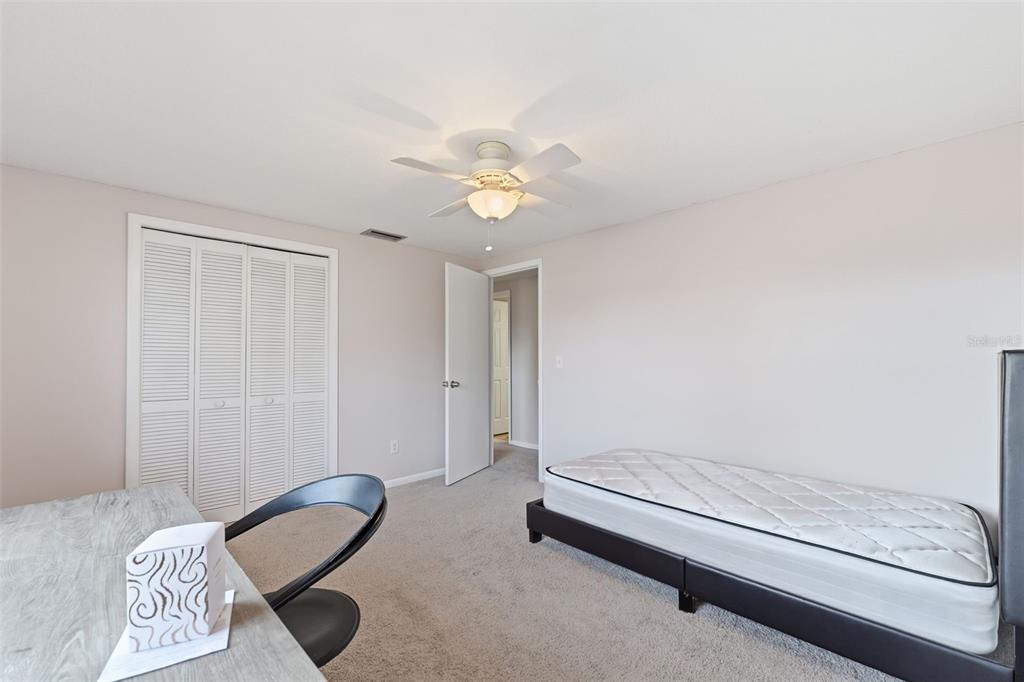 12935 Rain Forest Street Temple Terrace, FL 33617 - Photo 29 of 51 a bedroom with a bed and a chandelier