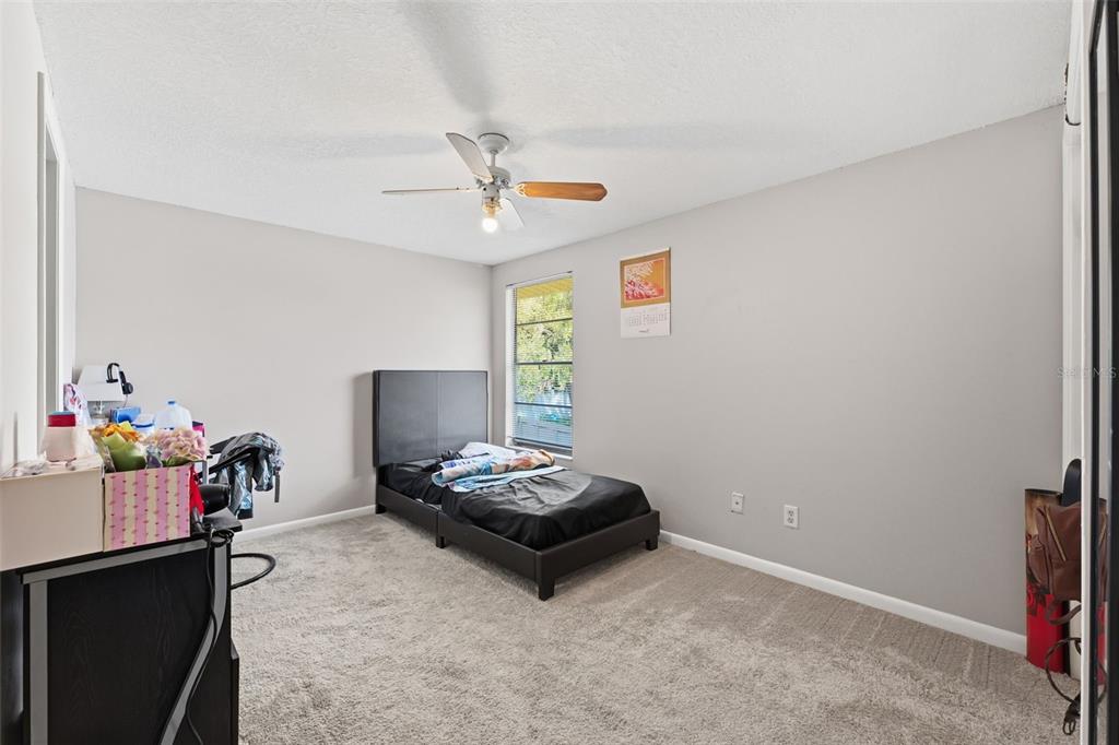 12935 Rain Forest Street Temple Terrace, FL 33617 - Photo 30 of 51 a living room with furniture and a flat screen tv