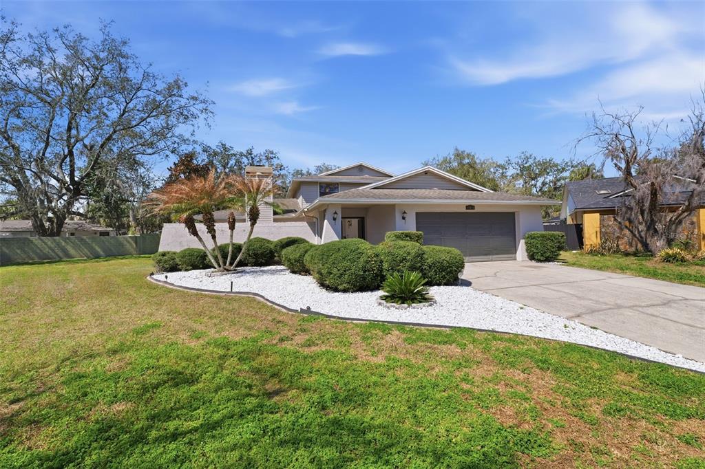 12935 Rain Forest Street Temple Terrace, FL 33617 - Photo 3 of 51 a front view of a house with a yard