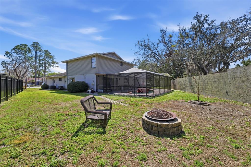 12935 Rain Forest Street Temple Terrace, FL 33617 - Photo 39 of 51 a front view of a house with swimming pool table and chairs