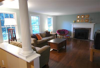 185 Indian Hill Road Barnstable, MA 02630 - Photo 3 of 10 a living room with furniture a fireplace and a large window