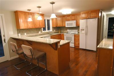 185 Indian Hill Road Barnstable, MA 02630 - Photo 4 of 10 a kitchen with stainless steel appliances granite countertop a refrigerator a sink a stove and island