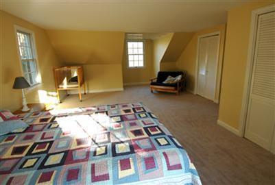 185 Indian Hill Road Barnstable, MA 02630 - Photo 6 of 10 a bedroom with a bed and a mirror on the wall