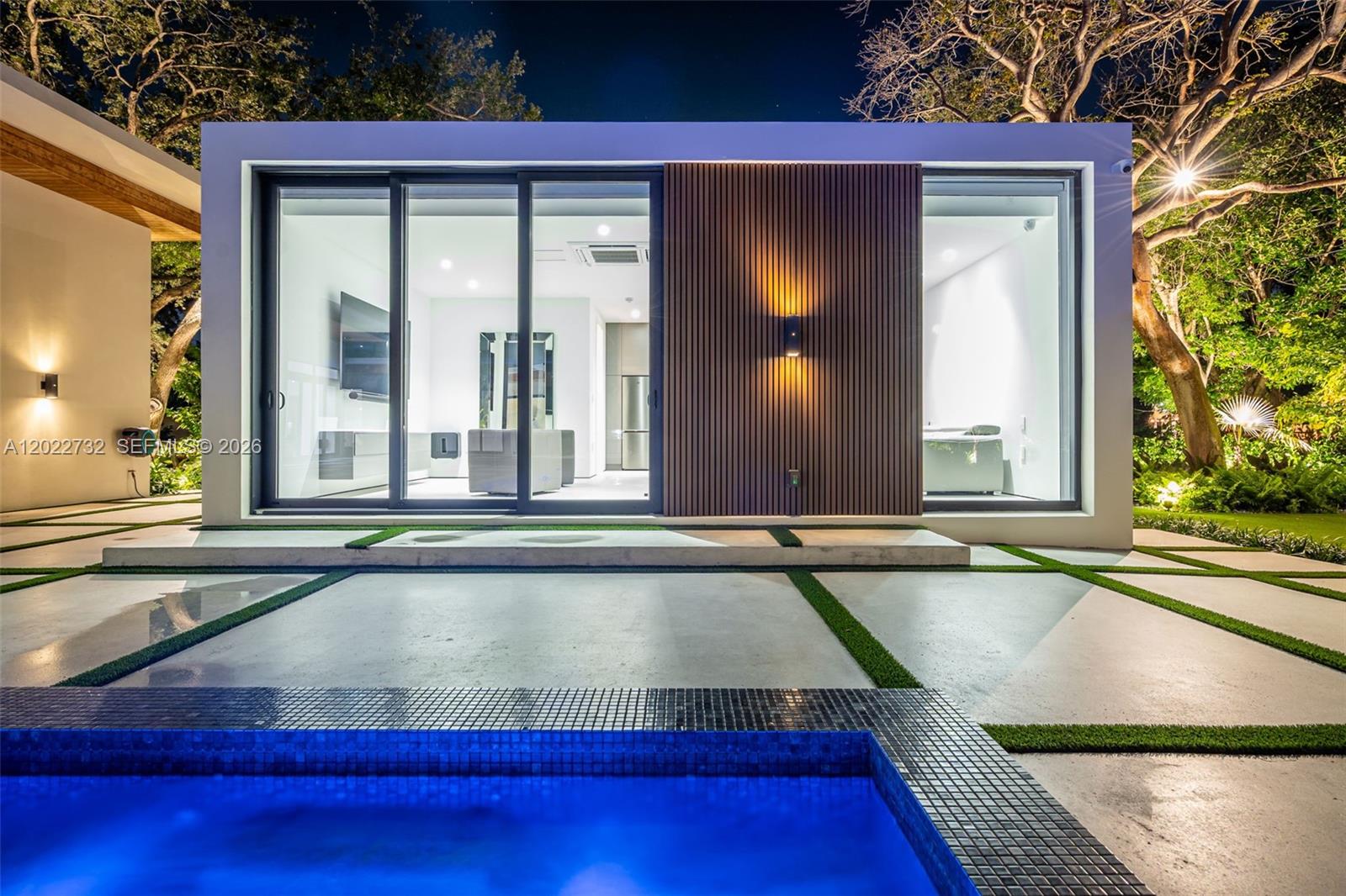 7825 Southwest 128th Street Pinecrest, FL 33156 - Photo 82 of 88 a view of a house with a swimming pool and sitting area